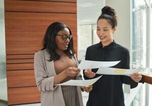 two women in an office setting discussing mental health insurance coverage
