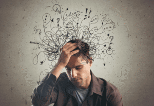 Person rubs head as he struggles his managing of ADHD symptoms