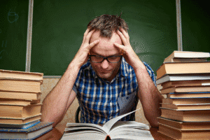 Man looks at books and tries to determine the differences between ADD vs ADHD