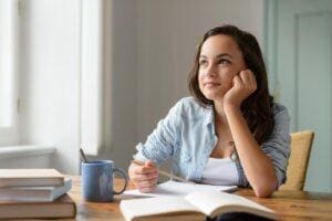 Woman sits at desk and wonders about managing inattentive ADHD