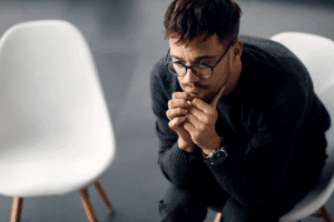 Man sits on chair and tries grounding techniques for anxiety