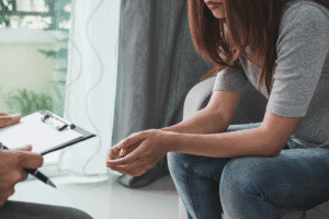 Woman sits and asks therapist "what is medication management?"