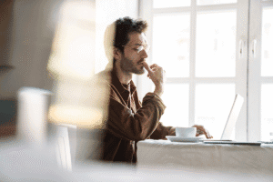 Man sits at desk and researches OCD subtypes