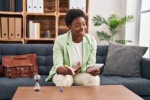 Woman sits on couch and wonders what psychotherapy is