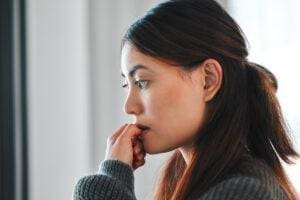 Woman chewing nails